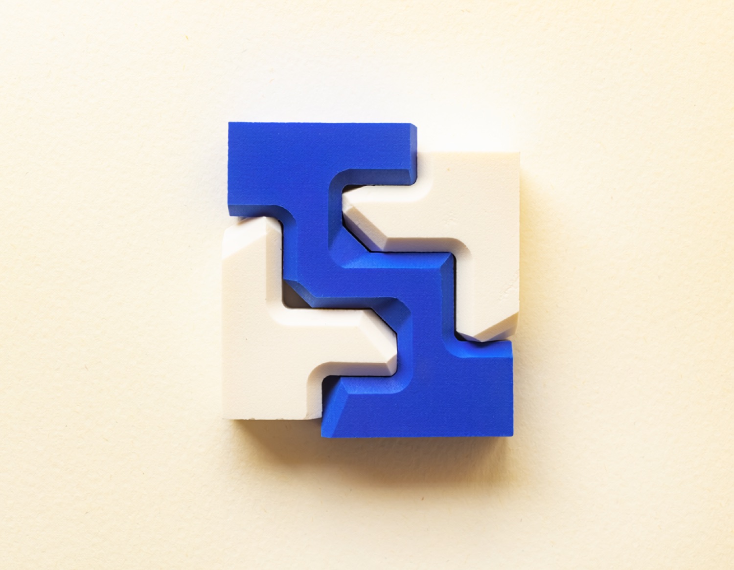 Four interlocking material components representing product definition, experience design, engineering and live operation as one connected capability